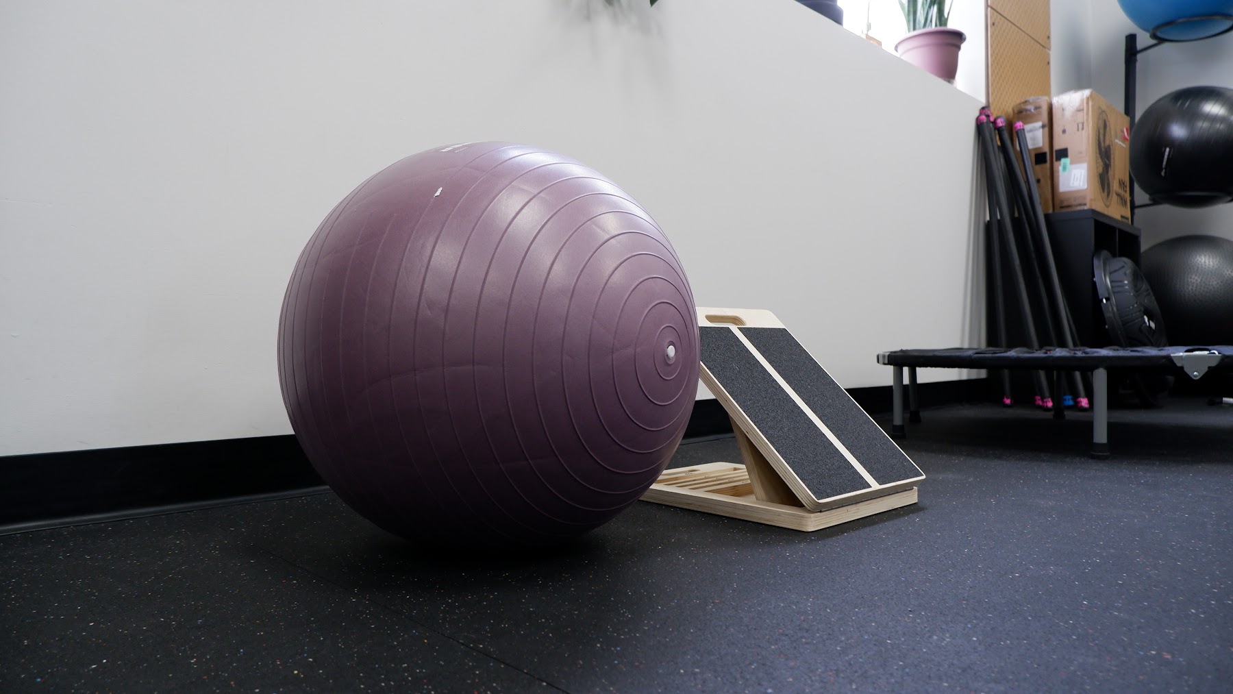 Stability ball and slant board set up on the floor